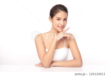 A beautiful young Asian woman with clean, fresh skin against a white background. Skincare, facial treatment, cosmetology, beauty, and spa. An elegant portrait of an Asian woman. 126120811