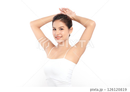 Beautiful Young Asian woman Raises her hands to Showcase clean and hygienic underarms Against a white background, Smooth armpit cleanliness and protection concept 126120819