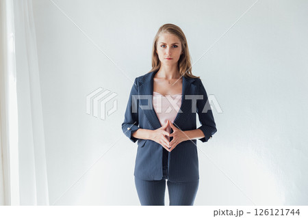 Portrait of a beautiful woman in a gray business suit 126121744