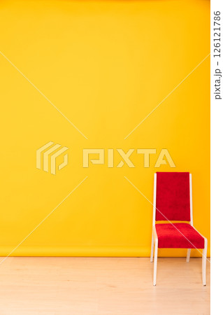red chair in the interior of a yellow room 126121786