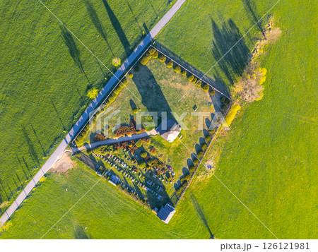 Overhead view of Tesarov Chapel and its surrounding graveyard in Korenov, situated in the picturesque Jizera Mountains of Czechia. 126121981