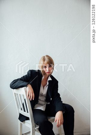Woman in Black Men's Suit Sitting on Chair Portrait 126122198