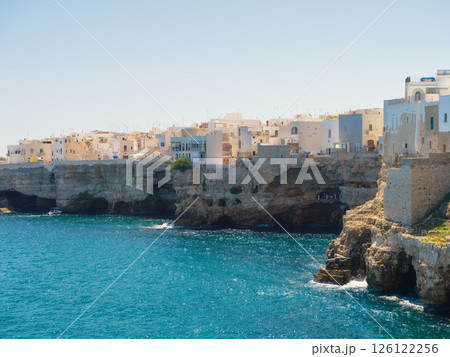 Polignano a Mare, Italy. View of the village. Old buildings on a cliff by the sea. Polignano a Mare, Italy. View of the village. Old buildings on a cliff by the sea. 126122256