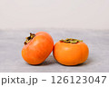 Ripe persimmon fruits on neutral light background 126123047