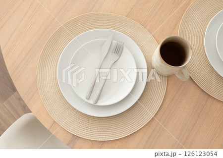 Minimalist table setting with coffee mug, top view 126123054