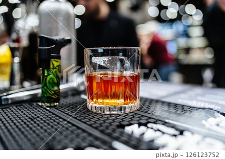 Enjoying a crafted cocktail at a lively bar in the heart of the city Enjoying a crafted cocktail at a lively bar in the heart of the city 126123752