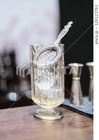 Elegant cocktail preparation in a stylish bar setting during evening hours Elegant cocktail preparation in a stylish bar setting during evening hours 126123761