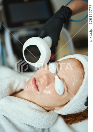 Skin treatment session in a wellness center using advanced technology 126123777