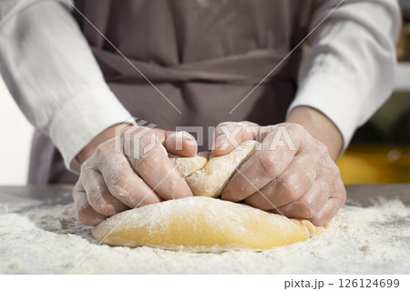 Baking concept. Caucasian female hands kneading the dough. Baking concept. Caucasian female hands kneading the dough. 126124699