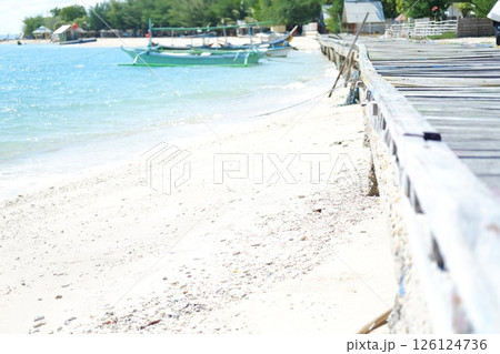 a peaceful beach scene with a wooden boardwalk running alongside a sandy shorelinea peaceful beach scene with a wooden boardwalk running alongside a sandy shoreline a peaceful beach scene with a wooden boardwalk running alongside a sandy shorelinea peaceful beach scene with a wooden boardwalk running alongside a sandy shoreline 126124736