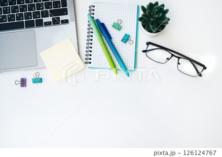 Flat lay home office workspace with laptop, diary, succulent plant and glasses on white background. Flat lay home office workspace with laptop, diary, succulent plant and glasses on white background. 126124767
