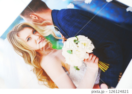 the pages of a photo book with wedding photos.  126124821