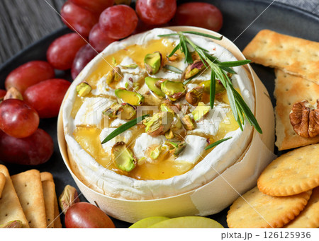 Baked Camembert with honey, pistachios, top view 126125936