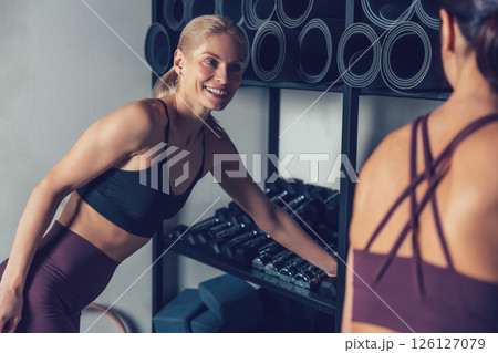 Two young caucasian women spending time together in the gym 126127079