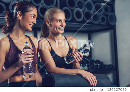Two young caucasian women spending time together in the gym 126127081
