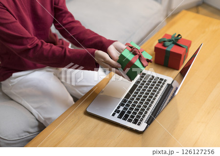 Celebrate on Christmas or new year season, asian woman hold a present box make video call during social distance, showing present, gift box on merry x'mas. Celebrate on Christmas or new year season, asian woman hold a present box make video call during social distance, showing present, gift box on merry x'mas. 126127256