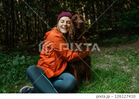 Joyful Moment with Dog in the Woods 126127410