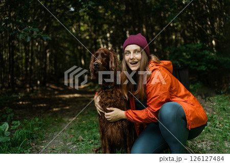 Adventurous Woman Hiking with Dog Adventurous Woman Hiking with Dog 126127484