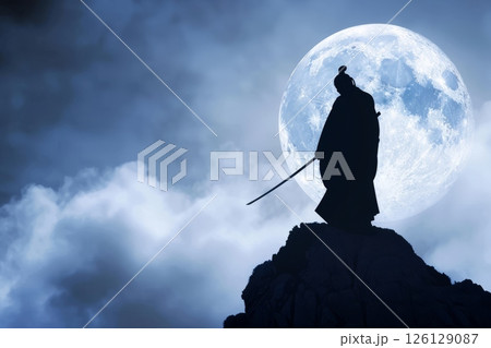Lone samurai standing on hill under full moon 126129087