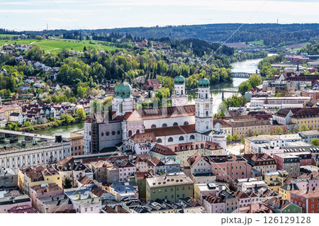 St. Stephans cathedral in Passau, Germany is an old white church with green metal domes on top of the towers 126129128