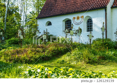 Church St.Clemens in Kranzberg near Freising, Bavaria with ancient graveyard and beautiful old wrought iron crosses 126129139