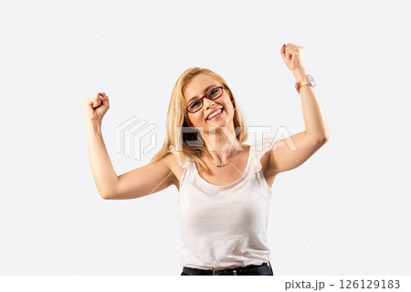 Winner happy blond woman celebrating success on white background Winner happy blond woman celebrating success on white background 126129183
