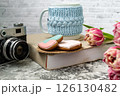 Pink tulips, an open book and a mug of freshly brewed coffee or tea. Spring set. Flatley layout 126130482