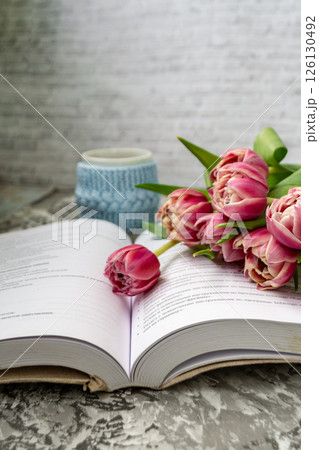 Pink tulips, an open book and a mug of freshly brewed coffee or tea. Spring set. Flatley layout 126130492