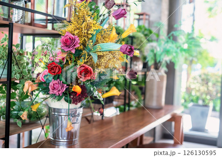 Artificial flower bouquet decor on table at cafe and restaurant Artificial flower bouquet decor on table at cafe and restaurant 126130595