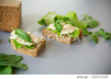 Isolated sandwich with rye bread and herring on the background 126131105