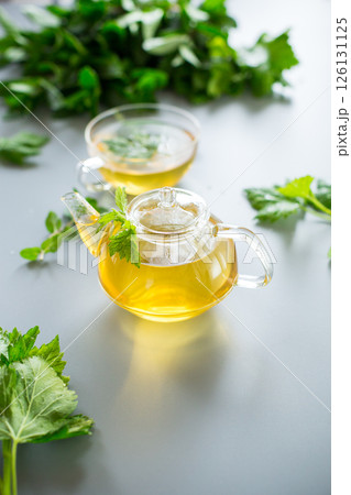 Green tea from currant leaves and mint in a glass container 126131125
