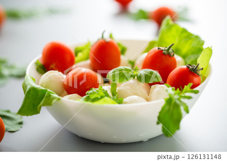 Delicious composition with mozzarella, cherry tomatoes and greens Delicious composition with mozzarella, cherry tomatoes and greens 126131148
