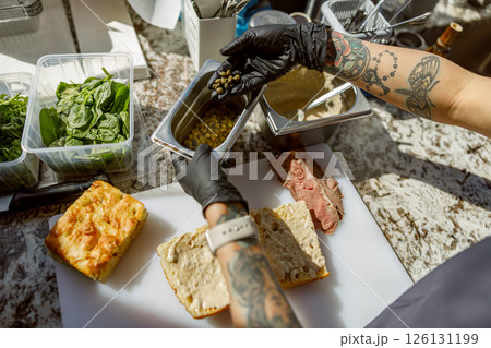 Crafting a Delicious Sandwich in a Contemporary and Stylish Modern Kitchen Environment Crafting a Delicious Sandwich in a Contemporary and Stylish Modern Kitchen Environment 126131199