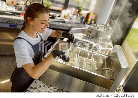 Barista Preparing Fresh Beverages in a Modern Caf Barista Preparing Fresh Beverages in a Modern Caf 126131219