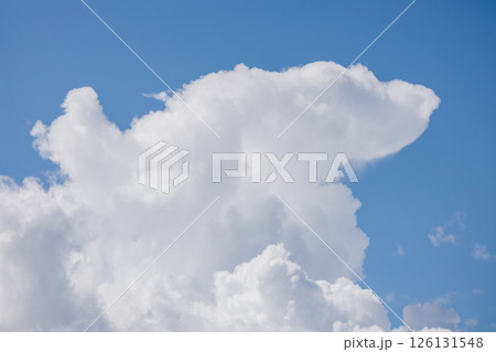 Fluffy white cloud in the blue sky. clear and cloudy weather, possible precipitation, rain. 126131548