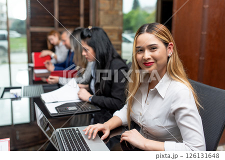 Portrait of smiling beautiful business woman at meeting in office. Portrait of smiling beautiful business woman at meeting in office. 126131648