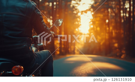 Motorcyclist Riding On Desolate Forest Road At Sunrise 126131910