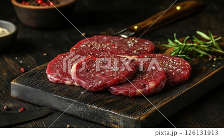 Assorted Raw Beef Steaks For Grilling With Seasoning And Tools On Dark Rustic Cutting Board 126131913
