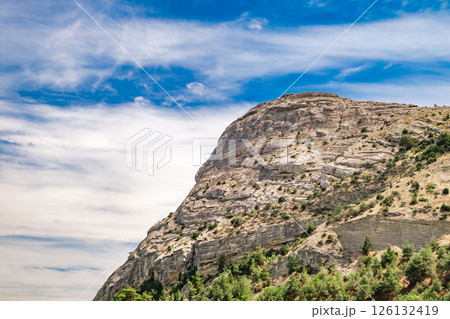 stone peak of mountain in close-up against the blue sky 126132419