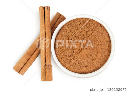 Cinnamon sticks with powder in ceramic bowl isolated on white background. Top view. Flat lay. 126132975