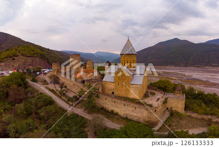 Aerial top view of Ananuri Fortress Complex on Aragvi River. Castle with old medieval orthodox church is tourist attraction. Georgian monastery at bank of Zinvali reservoir. Tbilisi, Georgia, Europe, 126133333