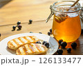 Warm Grilled Pancakes Topped With Syrup and Surrounded by Fresh Blueberries Sit Invitingly on a Plate 126133477