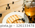 Toasted Bread With Honey and Blueberries, Warm Sunlight, Creating an Inviting Cafe-Inspired Atmosphere 126133478