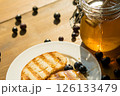 Toast With Honey and Blueberries on a Wooden Table, Creating a Sunny Breakfast Vibe, Perfect for Cafes and Food Blogs 126133479