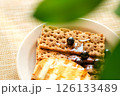 A Breakfast Platter Displays Whole Grain Crackers Drizzled With Honey, Garnished With Fresh Blueberries, Set on a Textured Cloth 126133489