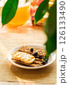 A Plate Holds Crunchy Crackers Topped With Fresh Blueberries, Set in a Vibrant Kitchen Filled With Sunlight and Cheerful Decor 126133490