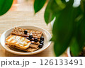 Beautifully Captured Honey and Blueberry Cracker Plate in Natural Light; Perfect for Health Blogs and Wellness Brands 126133491