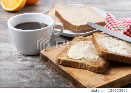 Sliced fresh bread and butter on wooden table Sliced fresh bread and butter on wooden table 126133595