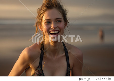 Portrait of a young woman running on the beach during sunset. A stunning sunset highlights the young woman's joyful run along the beach, capturing the essence of freedom. 126133716