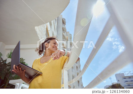 Woman Using Laptop Outdoors in Bright Sunny Weather, Wearing Yellow Shirt 126134060
